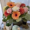 Bouquet of pink roses, orange gerberas, and white mums in a vase