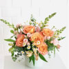 Peach and pink roses take center stage in this Summer Sunset flower