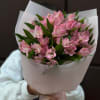 Bouquet of pink alstroemeria wrapped in white paper