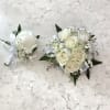 A single white rose boutonniere that reads as timeless and quietly elegant-the