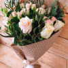 Bouquet of pale pink roses and small pink blooms in polka-dot wrap