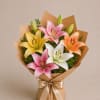 A compact and elegant bouquet featuring a refined mix of premium lilies