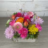 Mixed bouquet in a white rectangular box with pink, purple, and orange blooms