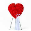 Heart-shaped red floral standing display with a white ribbon bow