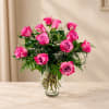 Pink roses arranged in a clear glass vase