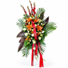 Standing floral spray with orange lilies, white roses, and red ribbon