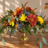 Autumn floral arrangement with chrysanthemums in a gold pedestal vase