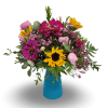 Mixed bouquet of pink, purple, and yellow flowers in a blue vase