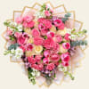 Pink and cream bouquet with roses, tulips, and carnations wrapped in paper