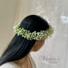 Woman wearing a white baby's breath flower crown in her hair