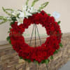 Red rose wreath with white lilies on a standing easel