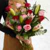 Bouquet of pink and red roses with lilies and eucalyptus