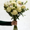 Handheld bouquet of white roses and lilies