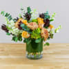 Bouquet of peach roses and chrysanthemums in a glass vase