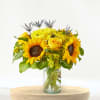 Sunflower and yellow rose bouquet in a clear glass vase