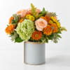 Peach roses and orange mums in a ceramic vase