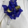 Blue flower boutonniere with white ribbon wrap