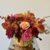 Autumn bouquet of mixed flowers in a pumpkin vase