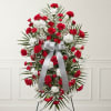 Standing wreath of red and white carnations with a silver ribbon