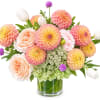 Peach and pink flowers in a glass vase with white tulips