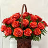 Basket of red roses with greenery