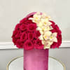 A romantic mix of rich hot pink roses and soft orchids arranged
