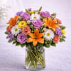 A vibrant and joyful arrangement that blends elegance with bold color. Radiant