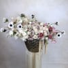 A stylish fusion of fresh, high-end flowers designed in a statement vase.