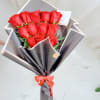Elegant bouquet of vibrant red roses, beautifully wrapped in premium black paper