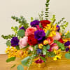 Colorful bouquet of roses and orchids in a gold vase