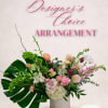 Mixed floral arrangement in a white vase with pink and white blooms