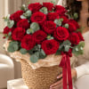 Basket of red roses with eucalyptus and a red ribbon
