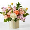 Mixed pink, peach, and white roses in a striped vase