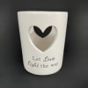 White ceramic candle holder with a heart cutout and "Let Love Light the way" text