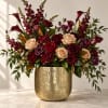 Mixed burgundy and blush floral arrangement in a gold vase