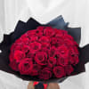 Bouquet of red roses wrapped in black paper