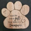 Wooden paw-shaped plaque with heart cutouts and a memorial message