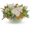 White roses in a pale green pumpkin-shaped container with autumn leaves