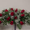 Large red rose arrangement with white baby's breath on a stand