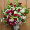 Beautiful red and white sympathy basket with roses, lilies and orchids