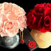 Two rose bouquets in round vases, one blush pink and one red