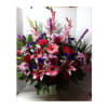Large mixed bouquet of pink, red, and purple flowers in a vase