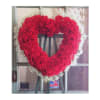 Heart-shaped red floral wreath on an easel