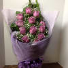 Bouquet of purple roses wrapped in lavender mesh