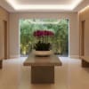 Purple orchids in a white bowl on a table in a modern room