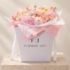 Pink and cream flower bouquet in a white gift box with ribbon