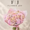 Large pink and cream bouquet wrapped in pink paper with ribbon