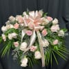 Pink and white rose spray with a satin bow and memorial ribbon