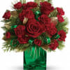 Red roses and carnations in a green glass vase with ribbon