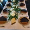 White and green wedding arrangement with dendrobium orchids and roses, a fresh